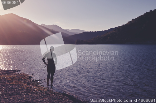 Image of triathlon athlete starting swimming training on lake