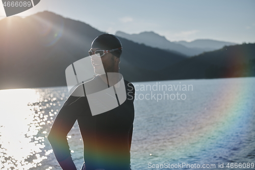 Image of triathlon athlete starting swimming training on lake