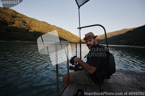 Image of videographer taking action shot of triathlon swimming athlete