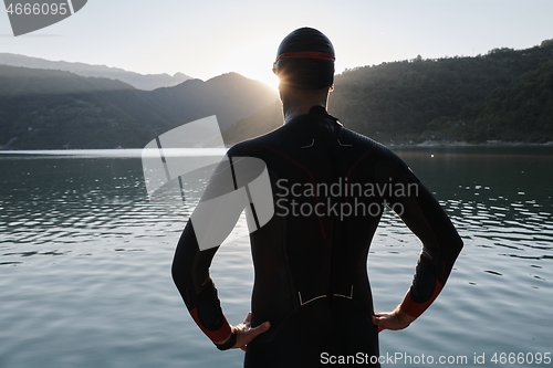 Image of triathlon athlete starting swimming training on lake