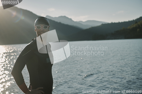 Image of triathlon athlete starting swimming training on lake