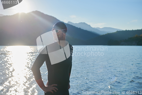 Image of triathlon athlete starting swimming training on lake