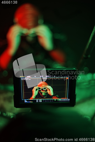 Image of videographer taking action shot of triathlon swimming athlete at night