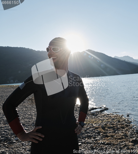 Image of triathlon athlete starting swimming training on lake