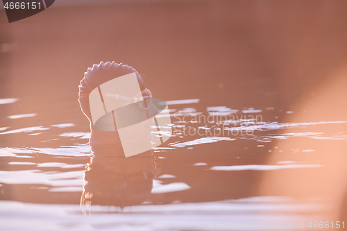 Image of triathlete swimmer having a break during hard training