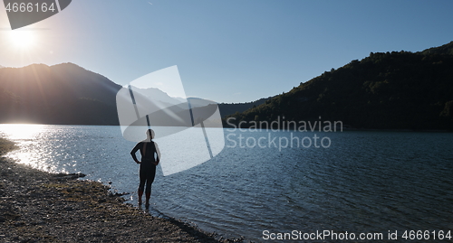 Image of triathlon athlete starting swimming training on lake