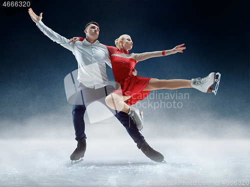 Image of Professional man and woman figure skaters performing on ice show