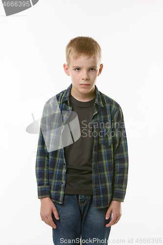 Image of Portrait of an annoyed boy of ten years on a white background