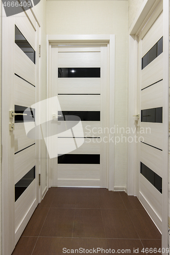 Image of Three closed interior doors in the corridor