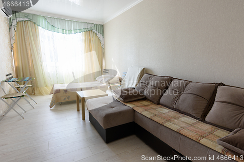 Image of The interior of the bedroom in the apartment with a large sofa