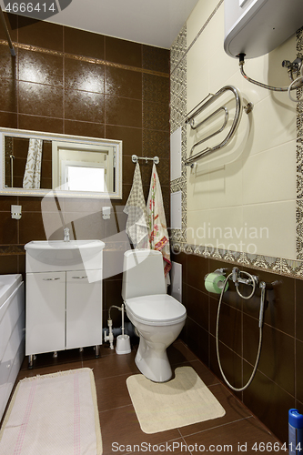 Image of Fragment of the interior of the bathroom, wall view toilet and washbasin