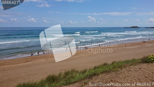 Image of ZARAUTZ, SPAIN- JULY 11, 2020: Aerial view to the Zarautz Beach with walking people, Basque Country, Spain on a beautiful summer day