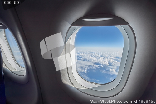 Image of Flying on airplane widow seat, clouds view