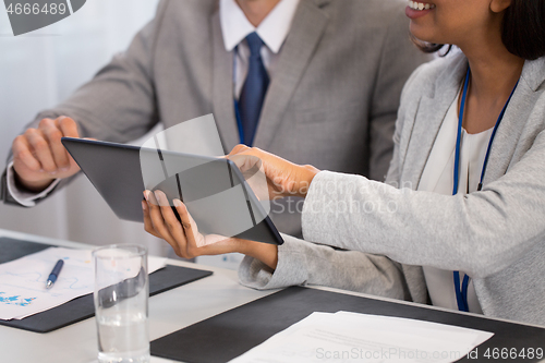 Image of people with tablet computer at business conference