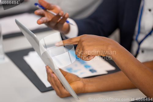 Image of people with tablet computer at business conference