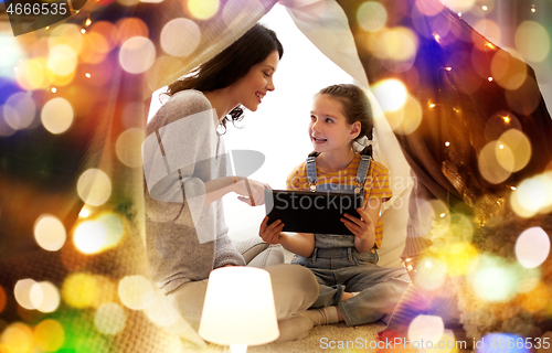 Image of family with tablet pc in kids tent at home