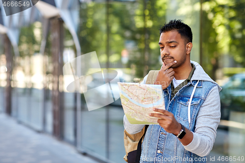 Image of indian man traveling with backpack and map in city