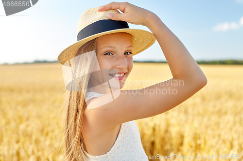 Image of portrait of girl in straw hat on field in summer