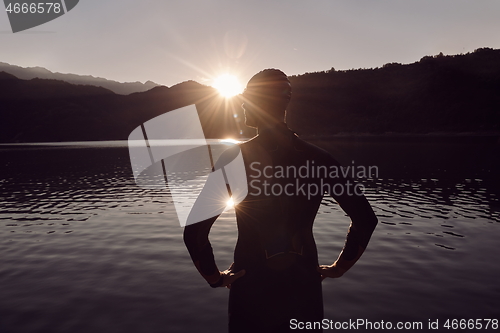 Image of triathlon athlete starting swimming training on lake