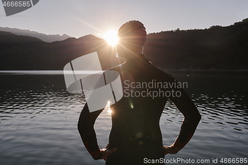 Image of triathlon athlete starting swimming training on lake