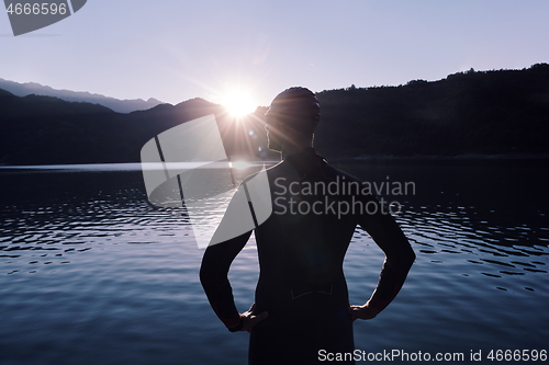 Image of triathlon athlete starting swimming training on lake