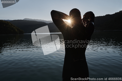 Image of triathlon athlete starting swimming training on lake