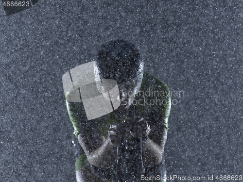 Image of triathlon athlete riding bike on rainy night