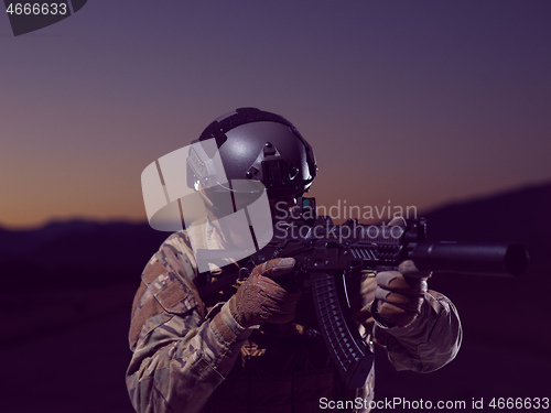 Image of soldier with full combat gear in night mission