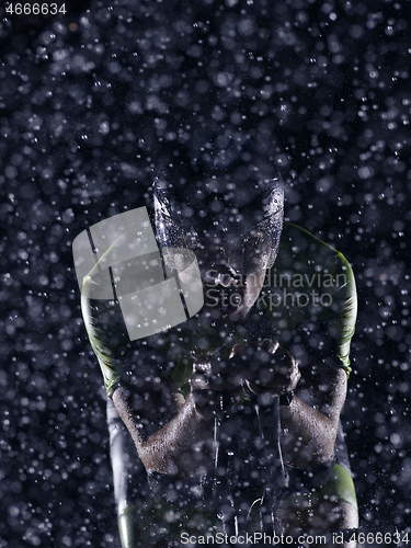 Image of triathlon athlete riding bike on rainy night