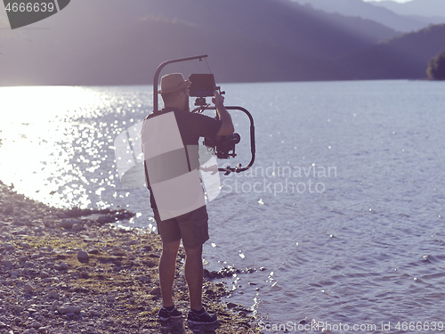 Image of videographer taking action shot of triathlon swimming athlete