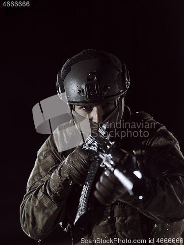 Image of soldier with full combat gear in night mission