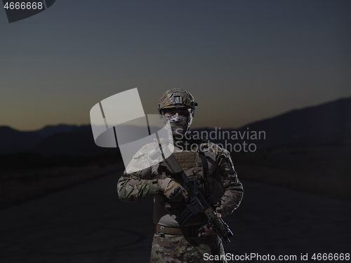 Image of soldier with full combat gear in night mission