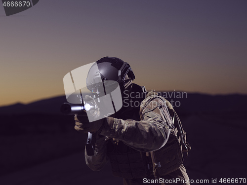 Image of soldier with full combat gear in night mission