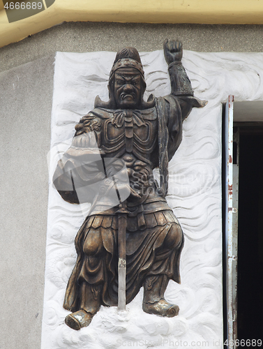 Image of Warrior relief at the entrance of a Buddhist temple