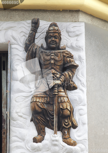 Image of Warrior relief at the entrance of a Buddhist temple