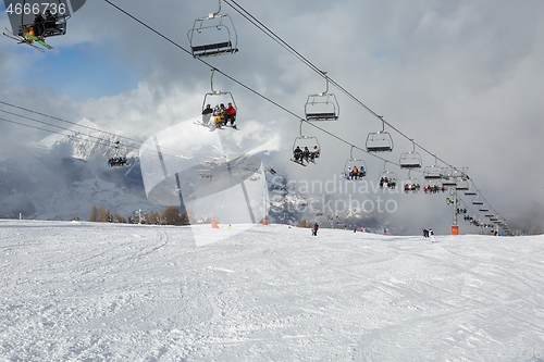 Image of Skiing slopes, with many people