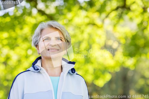 Image of smiling sporty senior woman at summer park