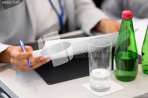 Image of close up of businesswoman with files at conference