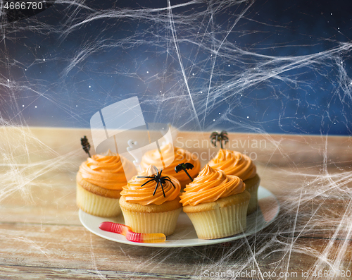 Image of halloween party cupcakes and jelly candy on table