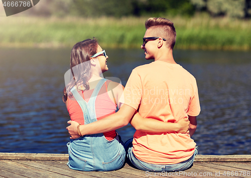 Image of happy teenage couple hugging on river summer berth