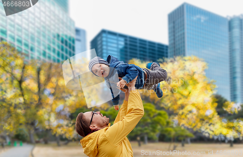 Image of father with son having fun in autumn tokyo city