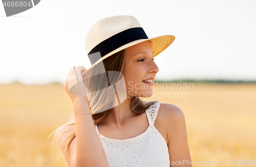 Image of portrait of girl in straw hat on field in summer