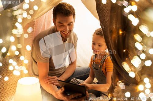 Image of family with tablet pc in kids tent at home