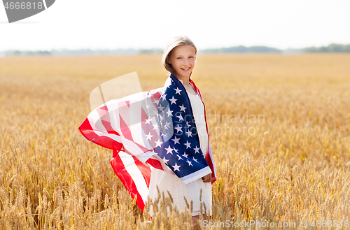 Image of happy girl in american flag on cereal field