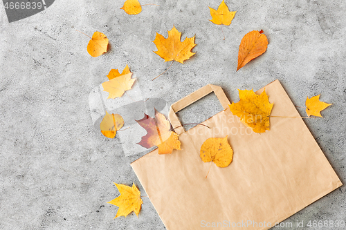 Image of autumn leaves and paper bag on grey stone