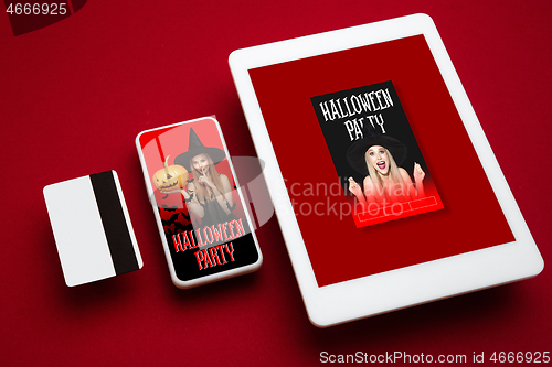 Image of Young woman in hat as a witch on device screen and red background, mock up with copyspace