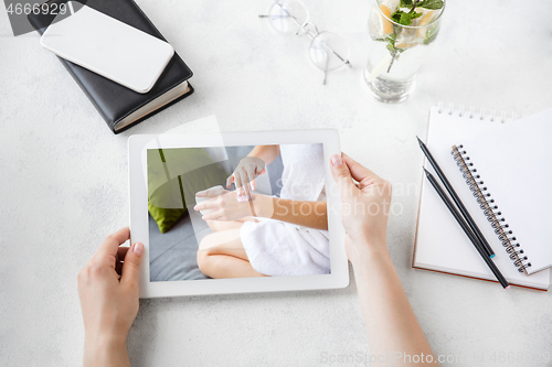 Image of Tablet with promotion of spa salon, cosmetics, beauty and self-care. Copyspace for ad