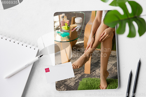 Image of Tablet with promotion of spa salon, cosmetics, beauty and self-care. Copyspace for ad