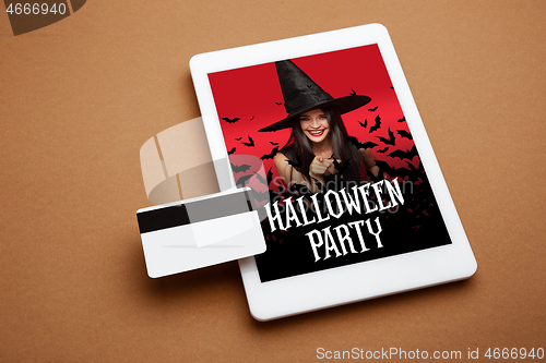 Image of Young woman in hat as a witch on device screen background, mock up with copyspace