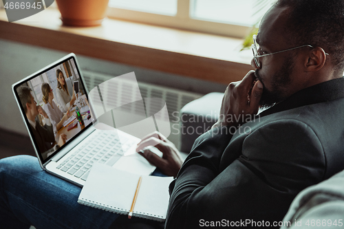 Image of Man working from home, remote office concept. Young businessman, manager doing tasks with laptop, has online conference.